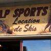Enseigne d'AP SPORTS, en bois et brou de noix, réalisée par un artisan du Louron.