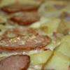 Flammekueche Franc Comtoise:
Saucisse de Montbéliard, Lardons, Oignons, Cancoillotte, Pomme de Terre