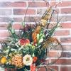 Composition tons orangés chez votre fleuriste Escale Fleurs