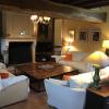 Grand séjour avec canapés, fauteuils, poufs, cheminée